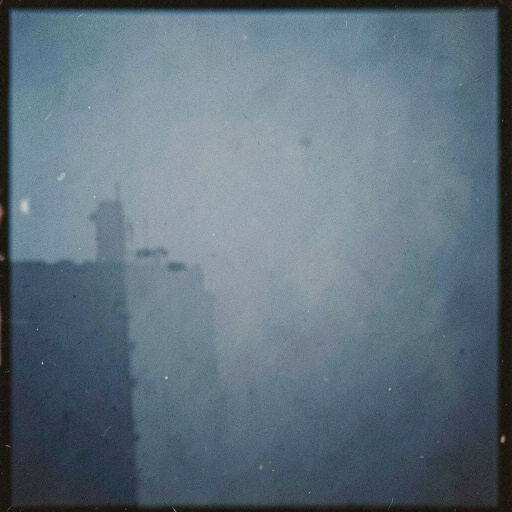 Abstract sculptural form with metallic and organic textures, muted earthy tones against a dark background